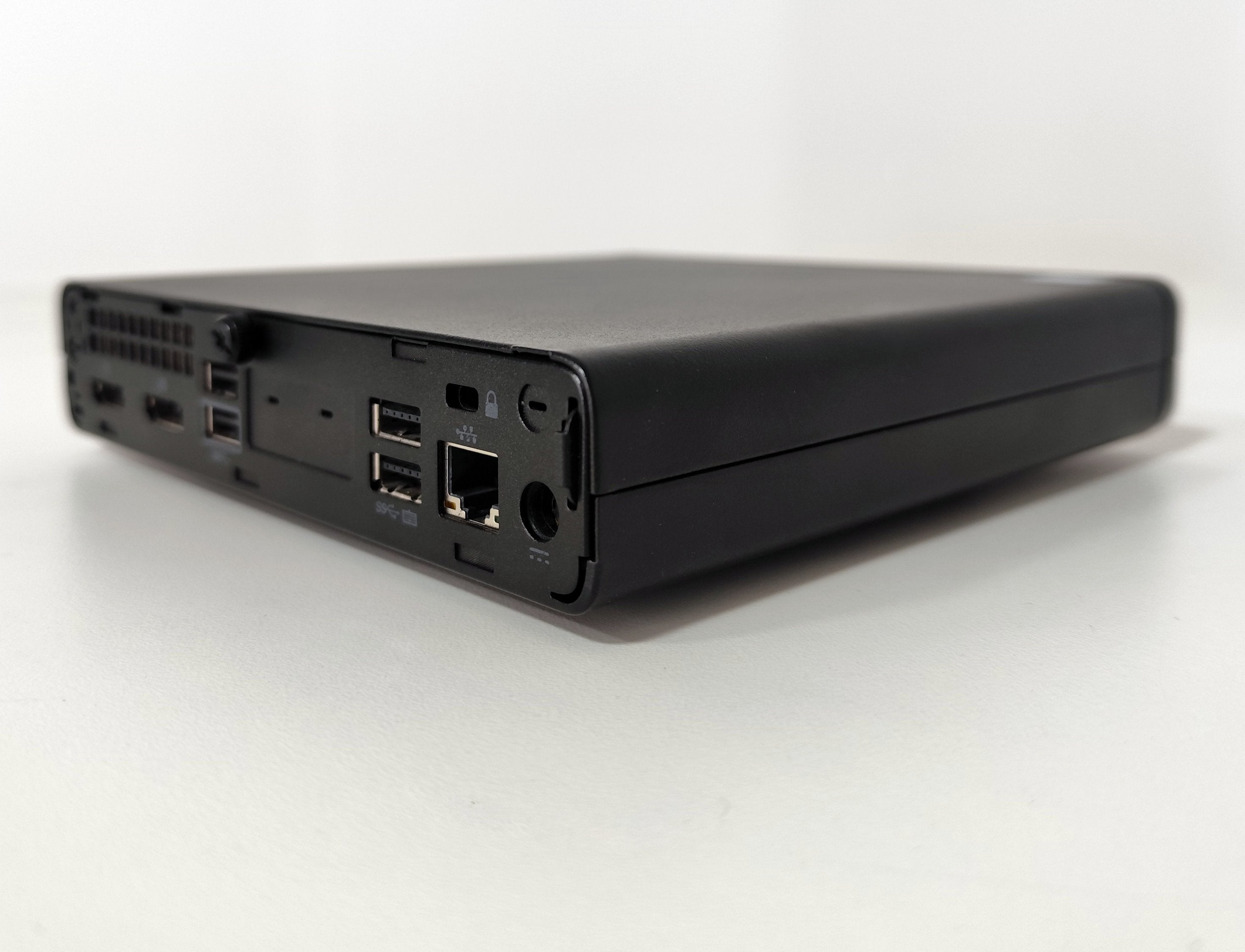 Refurbished compact mini PC with USB ports and Ethernet, on white background at qalnexvori.shop